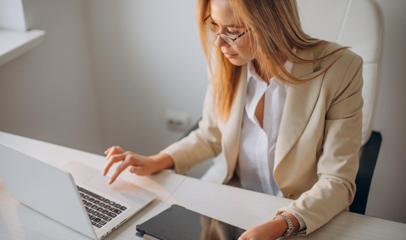 A businesswoman using laptop and tablet for paperless meetings