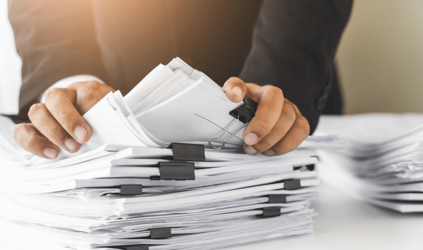 Corporate secretary compiling paper documents for the board pack